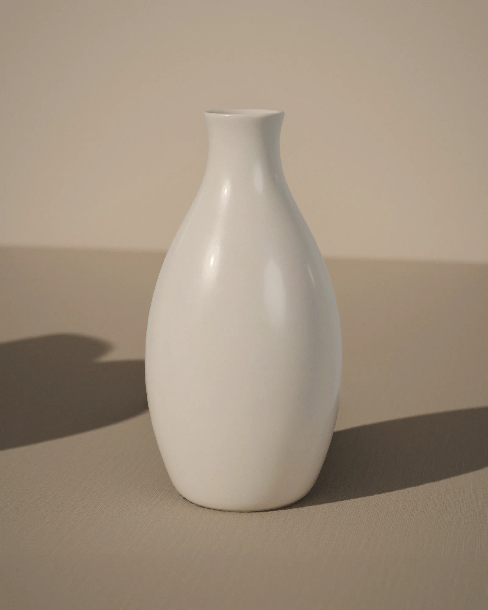 The tall vase in chalk, with the iron specks of the clay showing through